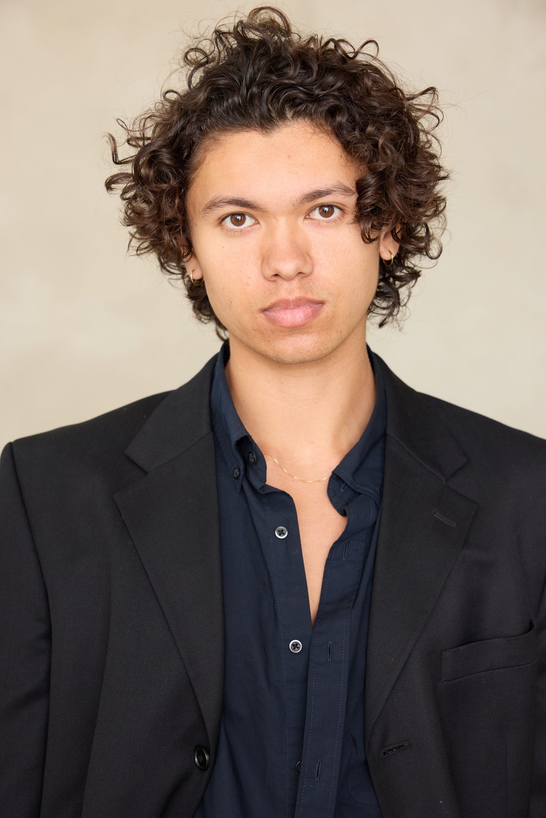 Quentin Lee headshot in black blazer