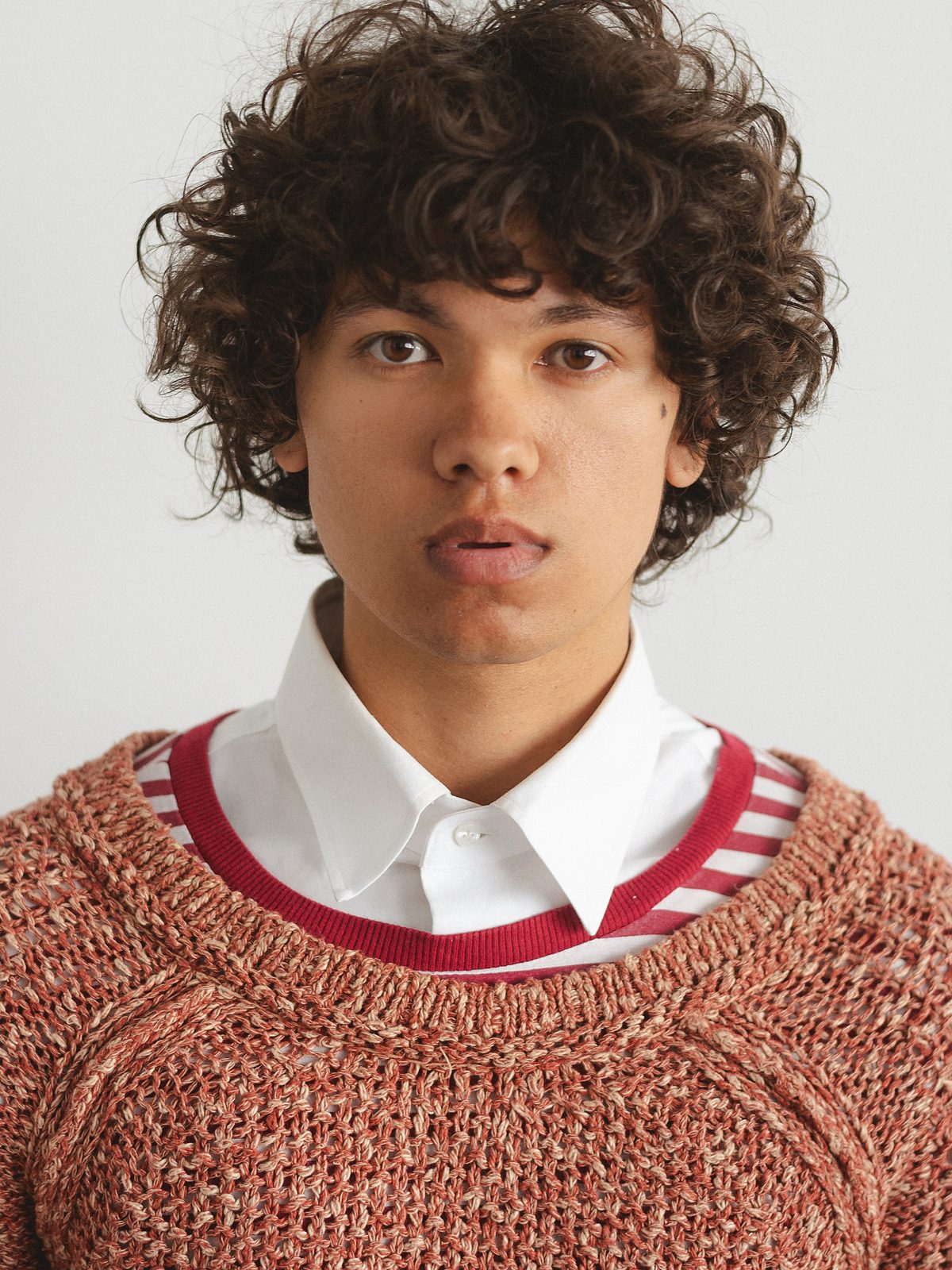 Close-up of Quentin Lee in rust knit sweater