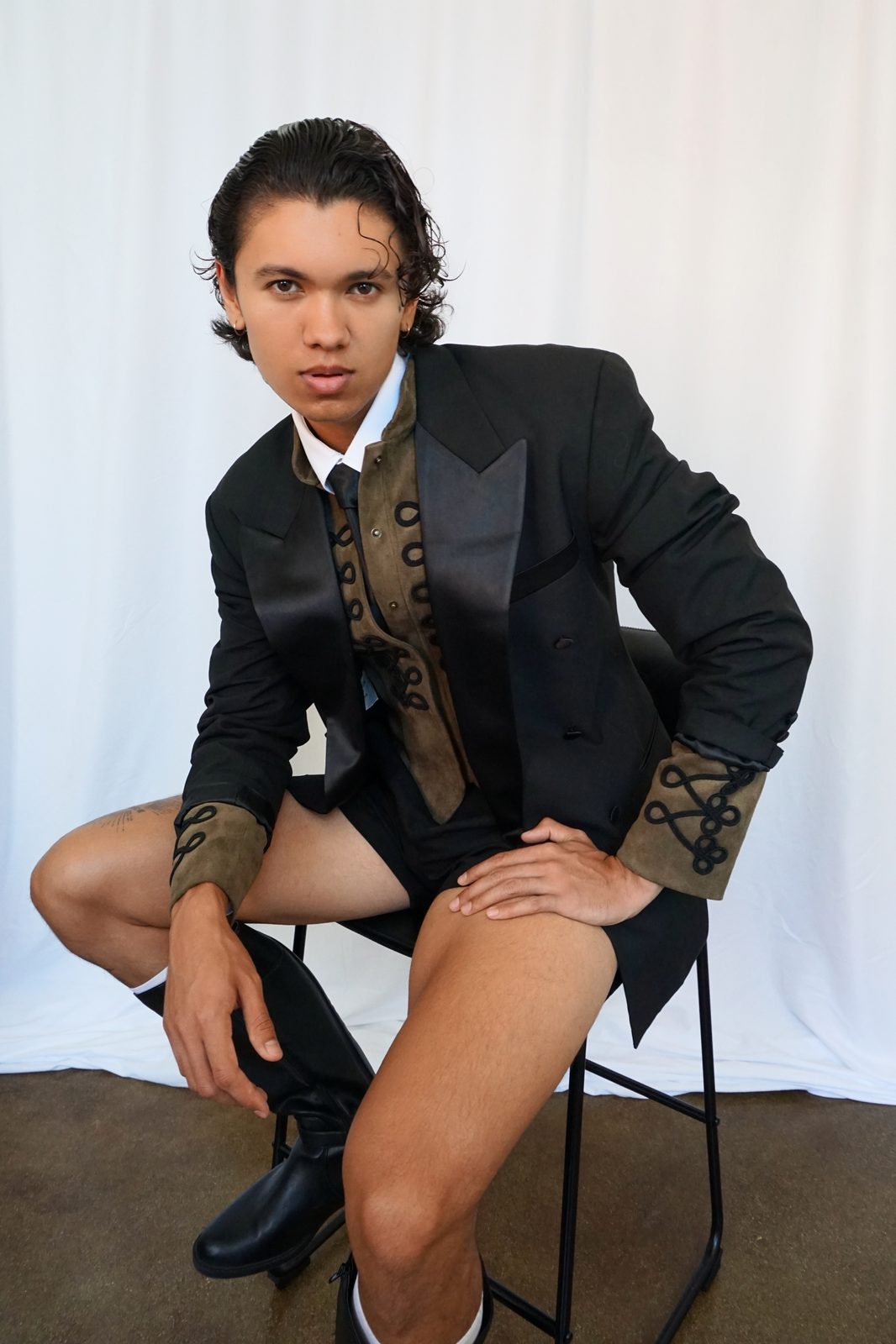 Quentin Lee in black tailored tuxedo jacket with embroidered cuffs