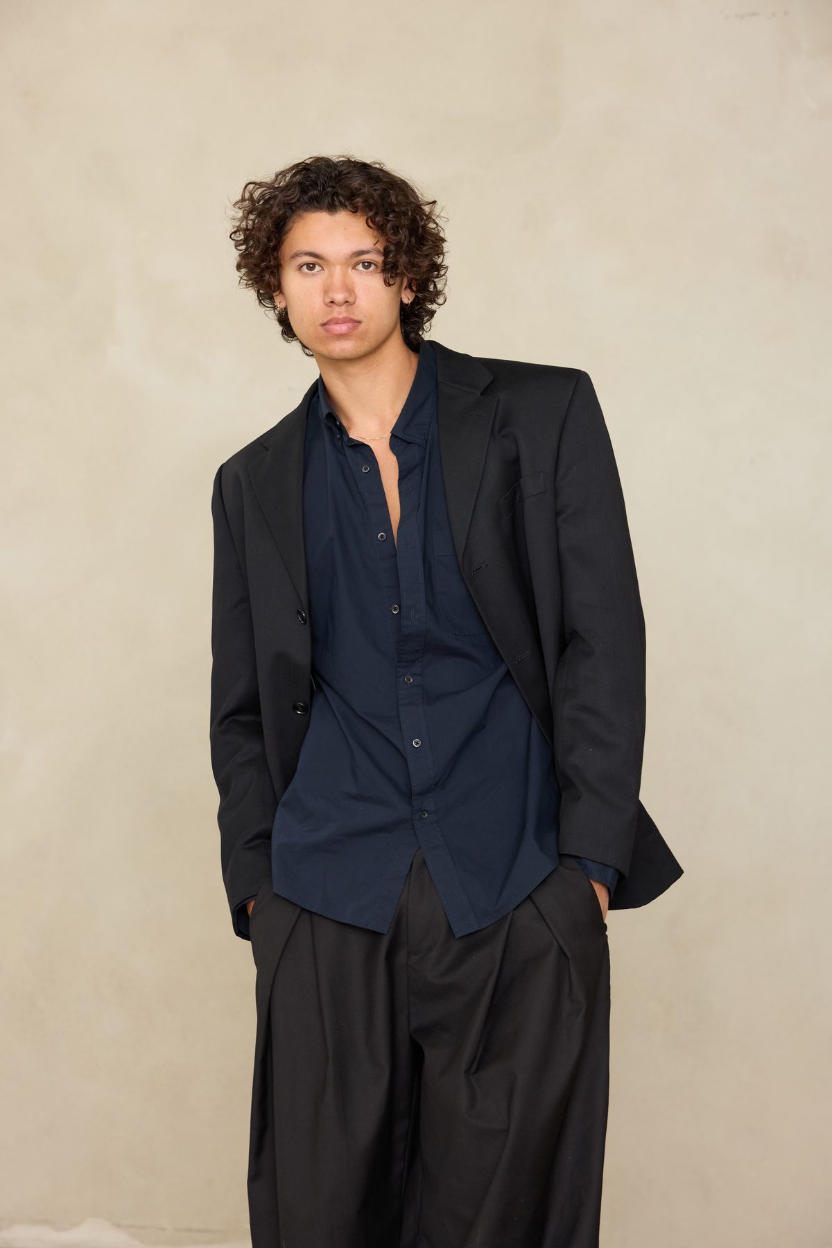 Quentin Lee in oversized black blazer and wide trousers